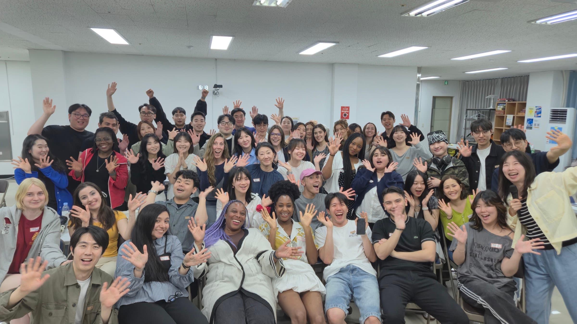Huge KND language exchange group of around sixty neighbors waving together